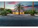 Inviting single-story home with desert landscaping, palm trees, and brick facade at 5486 Alfred Dr, Las Vegas, NV 89108
