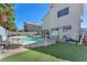 Spacious backyard featuring a pool, astroturf, and a large patio area perfect for entertaining at 5612 Royal Castle Ln, Las Vegas, NV 89130