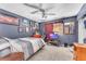 Cozy bedroom with a ceiling fan, eclectic decor, and carpeted floors for added comfort at 5612 Royal Castle Ln, Las Vegas, NV 89130