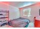 Simple bedroom with small window, carpeted floor and minimal furnishings at 5612 Royal Castle Ln, Las Vegas, NV 89130