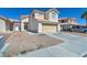 Two-story home with a two-car attached garage on a sunny day is great for a Gathering at 5612 Royal Castle Ln, Las Vegas, NV 89130