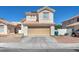 Charming two-story home featuring a neutral stucco exterior and a convenient two-car attached garage at 5612 Royal Castle Ln, Las Vegas, NV 89130