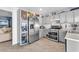 Well-lit kitchen featuring stainless steel appliances, light grey cabinetry, and wood-look flooring at 5612 Royal Castle Ln, Las Vegas, NV 89130