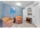 Cozy sitting area with orange patterned armchairs, a side table, and neutral carpeting at 5612 Royal Castle Ln, Las Vegas, NV 89130