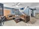 Cozy living room with a large sectional sofa, decorative pillows, and a staircase leading up at 5612 Royal Castle Ln, Las Vegas, NV 89130