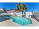 Inviting backyard pool area with lounge chairs, tables, and privacy fence at 5612 Royal Castle Ln, Las Vegas, NV 89130