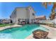 Inviting pool surrounded by a patio and lush landscaping creates a perfect backyard oasis at 5612 Royal Castle Ln, Las Vegas, NV 89130