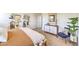 Comfortable bedroom featuring a king size bed, carpet, blue chair, plants and decor at 5702 Sunset Sedona St # Lot 2, North Las Vegas, NV 89081
