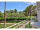 The balcony overlooks lush landscaping, mature trees, a manicured lawn, and a walking path at 572 Tam O Shanter, Las Vegas, NV 89109