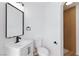 Modern bathroom features a white vanity and toilet, and a glass-enclosed shower at 572 Tam O Shanter, Las Vegas, NV 89109