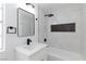 Bright bathroom with marble-look shower surround and black fixtures at 572 Tam O Shanter, Las Vegas, NV 89109