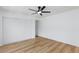 Bright bedroom with a ceiling fan, wood-look flooring, and sliding closet doors, featuring a neutral color palette at 572 Tam O Shanter, Las Vegas, NV 89109