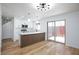 Dining area with contemporary lighting, an island with breakfast bar, and a sliding door to the patio at 572 Tam O Shanter, Las Vegas, NV 89109