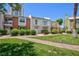 Charming two-story townhome with a brick and white exterior, set on a green lawn at 572 Tam O Shanter, Las Vegas, NV 89109