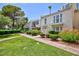 Attractive multi-level townhomes featuring balconies, lush lawns, and manicured landscaping at 572 Tam O Shanter, Las Vegas, NV 89109