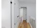 Bright hallway with white walls, wood-look flooring, and closet with dark hardware at 572 Tam O Shanter, Las Vegas, NV 89109
