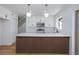 Modern kitchen with white cabinets, stainless steel appliances, breakfast bar with seating, and pendant lighting at 572 Tam O Shanter, Las Vegas, NV 89109