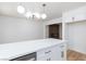 Bright kitchen with white cabinets, stainless steel dishwasher, and a large island with seating at 572 Tam O Shanter, Las Vegas, NV 89109