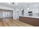 Bright, open kitchen with stainless steel appliances, pendant lighting, and breakfast bar with custom wood accents at 572 Tam O Shanter, Las Vegas, NV 89109
