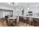 Bright kitchen and dining area boasts white cabinets, an island, and hardwood floors at 572 Tam O Shanter, Las Vegas, NV 89109