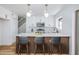 Modern kitchen with white cabinets, stainless steel appliances, breakfast bar with seating, and pendant lighting at 572 Tam O Shanter, Las Vegas, NV 89109