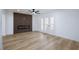 Spacious living room features wood-look floors and modern wall paneling with an electric fireplace at 572 Tam O Shanter, Las Vegas, NV 89109