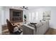 Stylish living room with modern wall paneling, electric fireplace, ceiling fan, and comfortable seating arrangement at 572 Tam O Shanter, Las Vegas, NV 89109