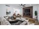 Cozy living room featuring contemporary decor, fireplace, ceiling fan, and view to the kitchen and dining area at 572 Tam O Shanter, Las Vegas, NV 89109