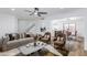 Bright and airy living room with open layout showcasing a view of the staircase, kitchen, and dining area at 572 Tam O Shanter, Las Vegas, NV 89109