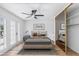 Staged main bedroom with fan, closet, and door to balcony at 572 Tam O Shanter, Las Vegas, NV 89109