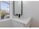 Stylish powder room features modern vanity with vessel sink and minimalist mirror with neighborhood view at 572 Tam O Shanter, Las Vegas, NV 89109
