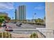 Condo view of street with mature trees, parked cars, and blue skies in Las Vegas at 572 Tam O Shanter, Las Vegas, NV 89109