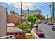 Las Vegas townhome overlooking street, carport, and mature shade trees on a beautiful day at 572 Tam O Shanter, Las Vegas, NV 89109