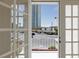 Balcony view of the city skyline, including the Stratosphere Tower, through white french doors at 572 Tam O Shanter, Las Vegas, NV 89109