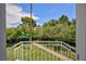 Balcony view of lush backyard landscape with grass, trees, and community swimming pool at 572 Tam O Shanter, Las Vegas, NV 89109