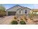 Charming home with a brick driveway, desert landscaping, and attached two car garage at 605 Cadence Vista Dr, Henderson, NV 89011