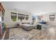 Spacious living room with large sectional sofa and woven window shades offers comfortable gathering space at 605 Cadence Vista Dr, Henderson, NV 89011
