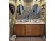Bathroom featuring a double vanity sink and updated wall mirrors at 6363 Berry Patch Way, Las Vegas, NV 89142