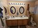 Bathroom features dual sinks, round mirrors, and sufficient vanity storage at 6363 Berry Patch Way, Las Vegas, NV 89142