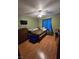 Cozy bedroom with wood floors, ceiling fan, and blue curtains at 6363 Berry Patch Way, Las Vegas, NV 89142