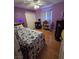 Charming bedroom boasts purple walls and a playful theme, creating an inviting space at 6363 Berry Patch Way, Las Vegas, NV 89142