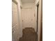 Hallway with neutral carpeting, white doors, and access to multiple rooms at 6363 Berry Patch Way, Las Vegas, NV 89142