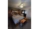 Spacious main bedroom with wood furnishings, including a large bed frame, and a ceiling fan at 6363 Berry Patch Way, Las Vegas, NV 89142