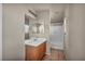 Bathroom with single sink vanity, large mirror, and shower-tub combo at 6377 W Haleh Ave, Las Vegas, NV 89141