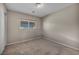 Neutral bedroom featuring neutral walls and carpet, with a view from the window at 6377 W Haleh Ave, Las Vegas, NV 89141