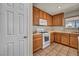 Bright kitchen featuring wood cabinets, white appliances, and neutral countertops at 6377 W Haleh Ave, Las Vegas, NV 89141