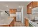 Spacious kitchen with an island, tile floors, white appliances, and wood cabinets at 6377 W Haleh Ave, Las Vegas, NV 89141