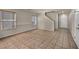 Spacious living room features tiled floors, neutral walls, with plenty of sunlight with stairway access to the second floor at 6377 W Haleh Ave, Las Vegas, NV 89141