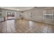 Open floor plan showcasing neutral wall paint and ample natural lighting with large sliding door access to backyard at 6377 W Haleh Ave, Las Vegas, NV 89141