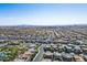 Wide aerial perspective showing the entire community with houses and desert landscape in the distance at 6433 Farness St, Las Vegas, NV 89135